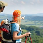 Hiking young couple point at panoramic view