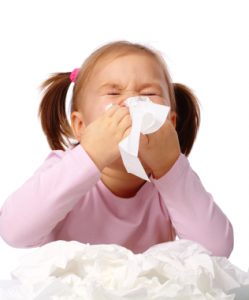 Little girl blows her nose