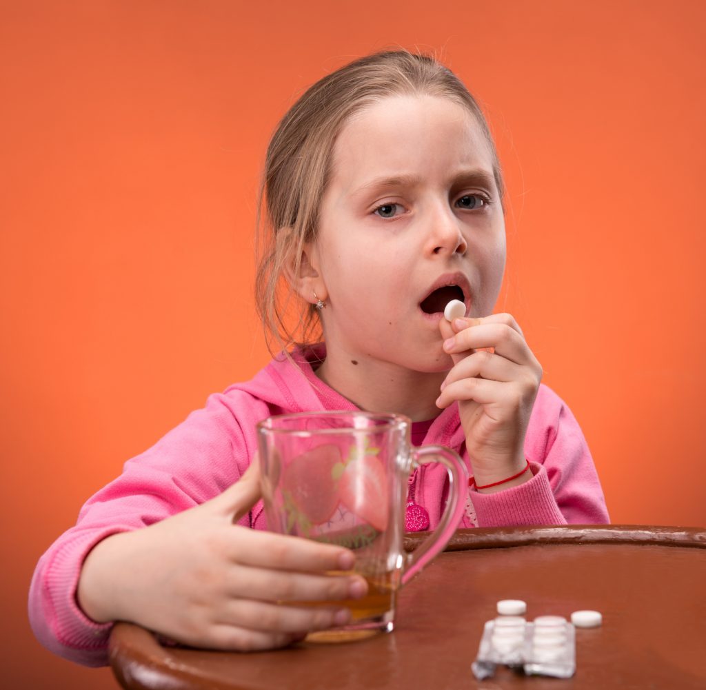 Girl looks very upset at the thought of taking her medicine